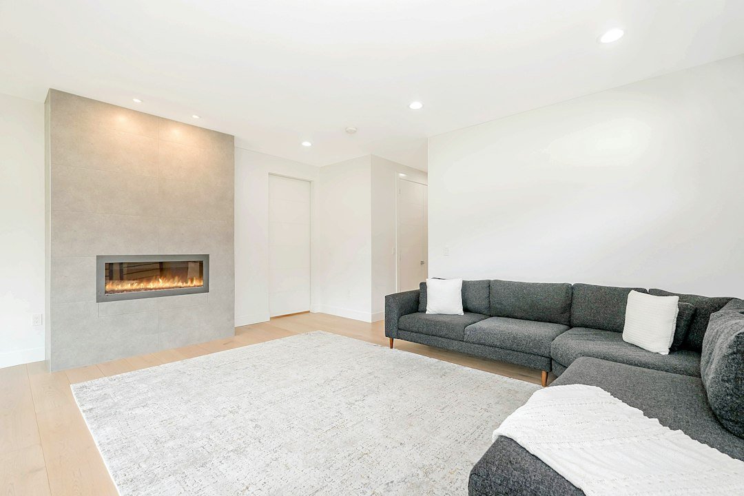Bright family room design inspiration with sectional seating and a fireplace